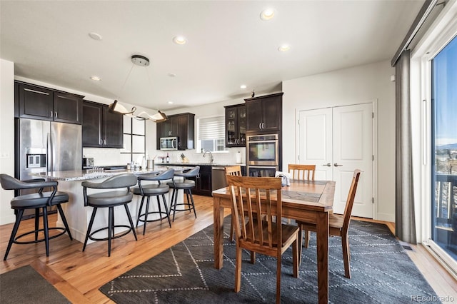 dining area featuring dark hardwood / wood-style flooring, plenty of natural light, and sink