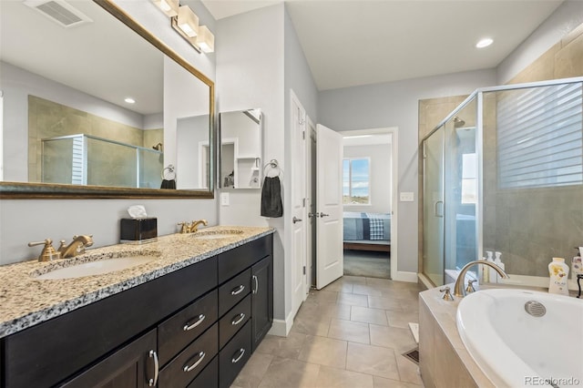 bathroom featuring tile patterned flooring, vanity, and independent shower and bath