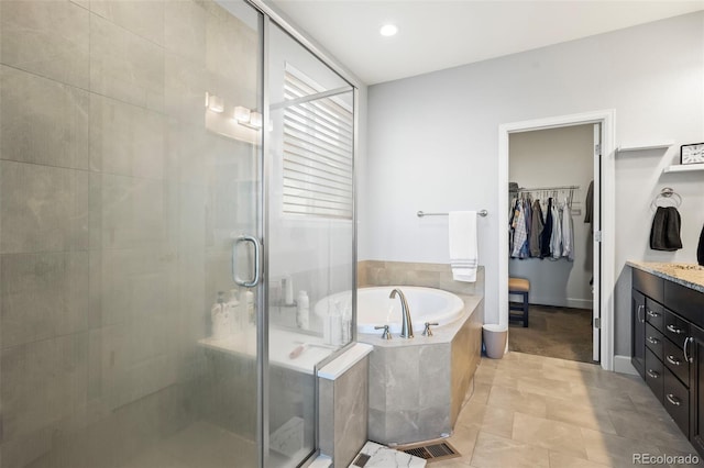 bathroom featuring tile patterned floors, vanity, and separate shower and tub