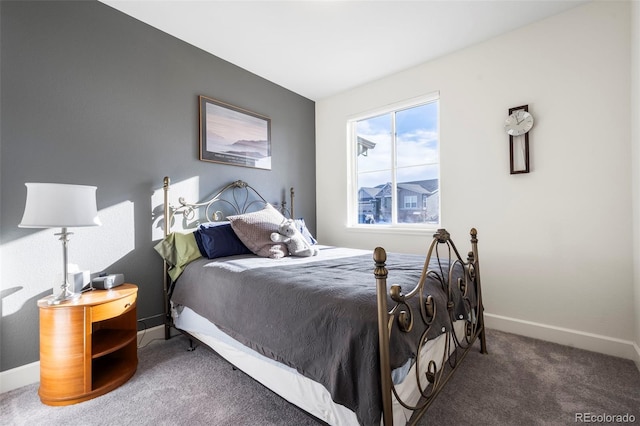 bedroom with dark colored carpet