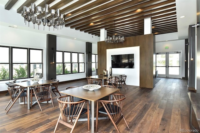 dining area with beamed ceiling, plenty of natural light, and dark hardwood / wood-style flooring