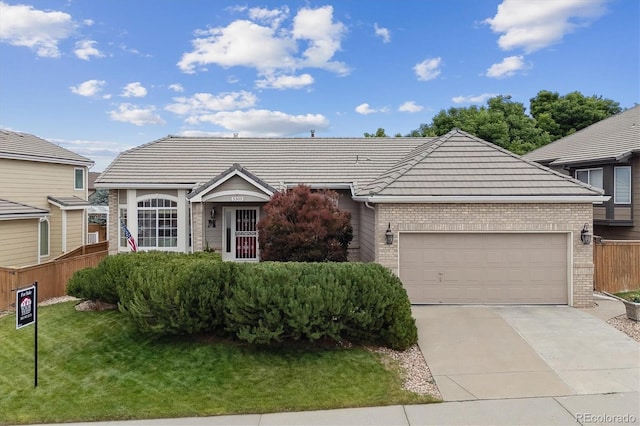 3305 White Oak Ln, Highlands Ranch, CO 80129 - view of front facade featuring brick siding, driveway, an attached garage, and a tiled roof