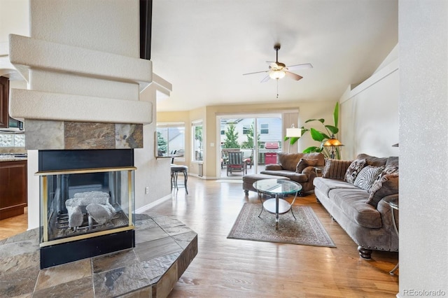 3305 White Oak Ln, Highlands Ranch, CO 80129 - living room with a ceiling fan, wood finished floors, and a tiled fireplace