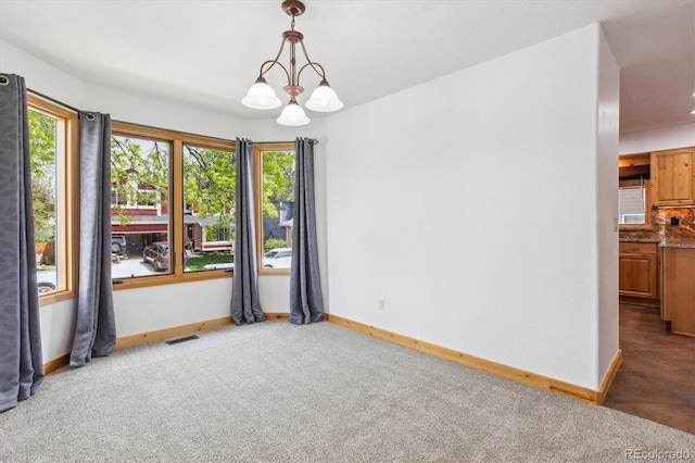 5282 Devon Ave, Castle Rock, CO 80104 - carpeted empty room with baseboards, plenty of natural light, and a chandelier