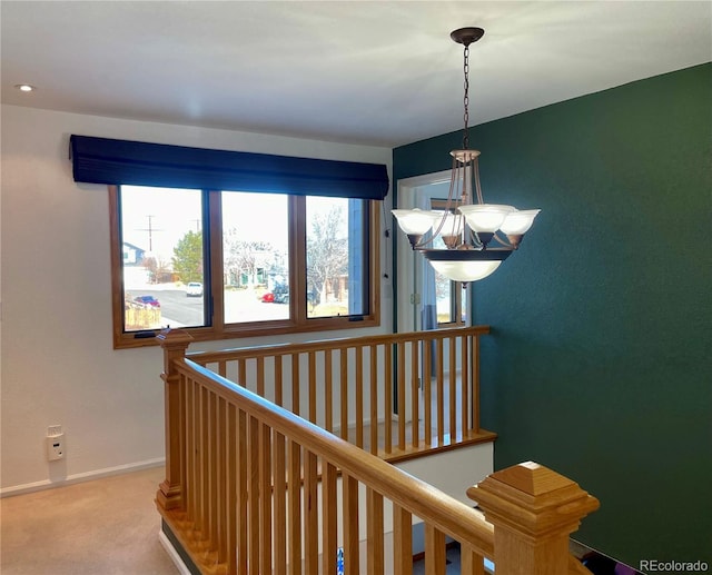 5282 Devon Ave, Castle Rock, CO 80104 - hall featuring light carpet, a chandelier, baseboards, and an upstairs landing