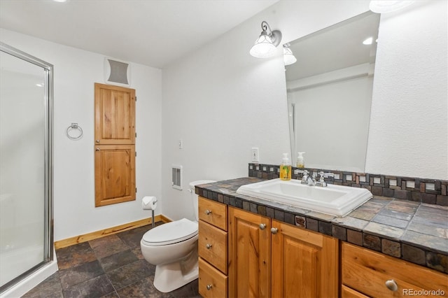 5282 Devon Ave, Castle Rock, CO 80104 - full bathroom featuring a shower stall, toilet, vanity, stone finish flooring, and baseboards
