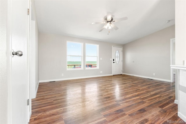 foyer featuring a ceiling fan, dark wood finished floors, vaulted ceiling, and baseboards