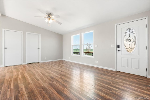 entryway with vaulted ceiling, ceiling fan, wood finished floors, and baseboards