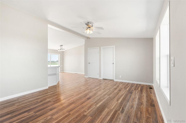 unfurnished room featuring a ceiling fan, wood finished floors, and baseboards