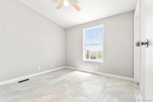 empty room with ceiling fan and baseboards