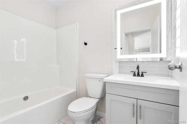 bathroom with decorative backsplash, vanity, and toilet
