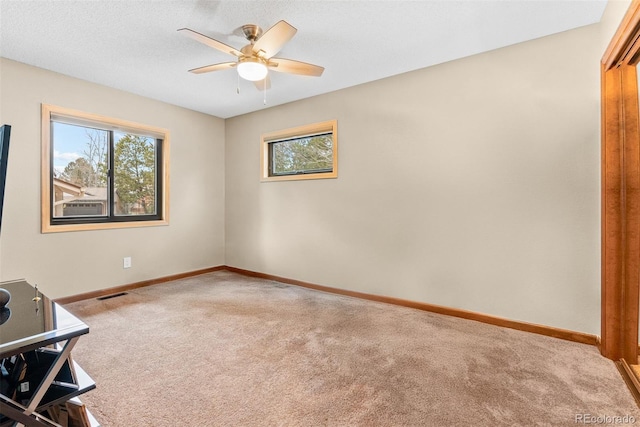 interior space with carpet flooring and ceiling fan