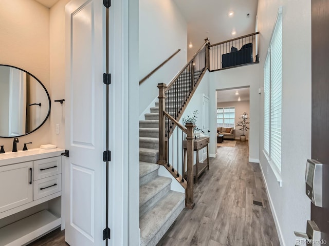 stairs featuring baseboards and wood finished floors