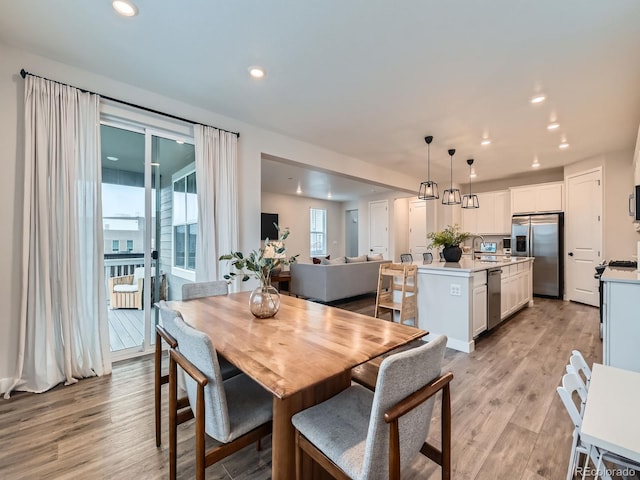 dining space featuring light wood-type flooring and recessed lighting
