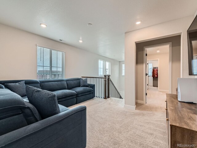 living area with light colored carpet, baseboards, and recessed lighting