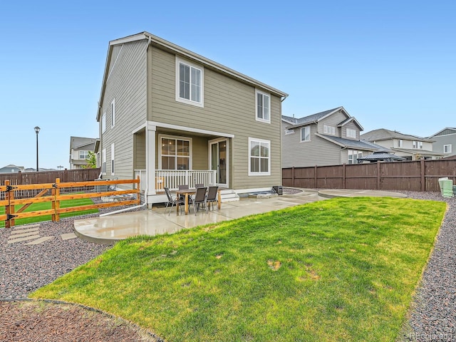 rear view of property featuring a patio area