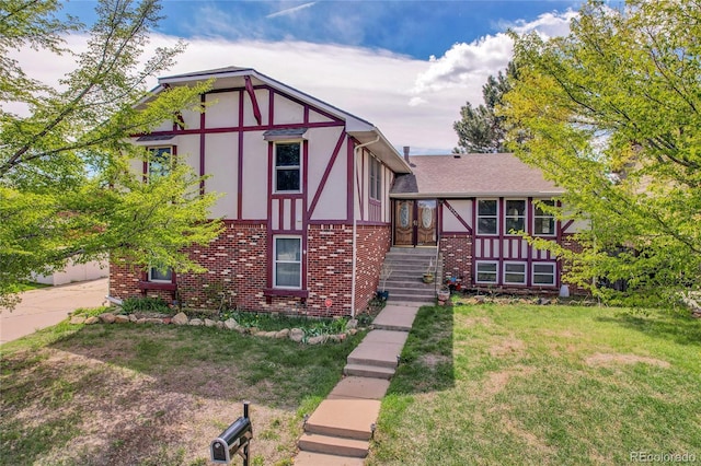 tudor-style house with brick siding and a front lawn