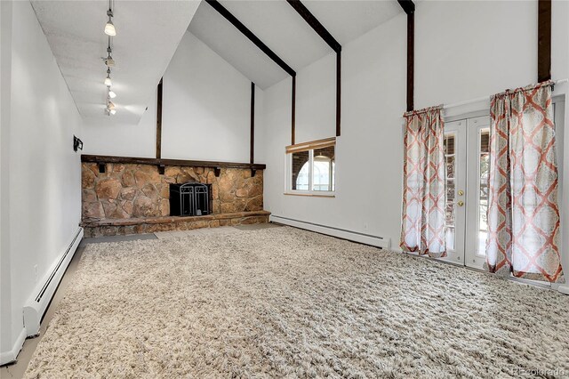 unfurnished living room featuring baseboard heating, high vaulted ceiling, track lighting, french doors, and carpet flooring