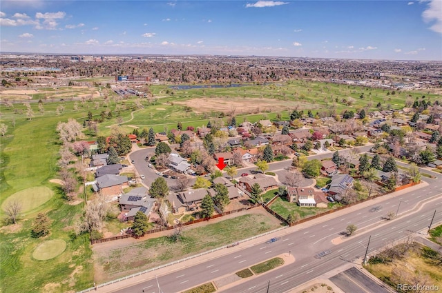 aerial overview of property's location with nearby suburban area and a local golf course