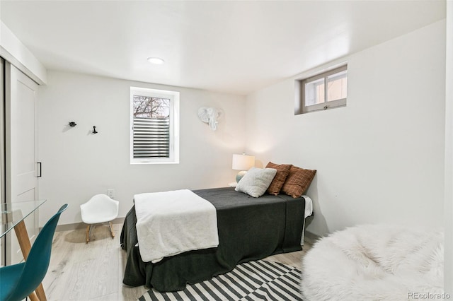 bedroom featuring a closet and light hardwood / wood-style flooring