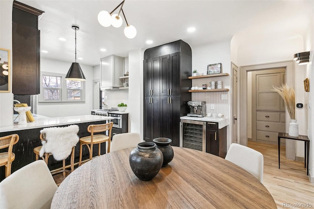 dining room featuring light hardwood / wood-style floors and beverage cooler