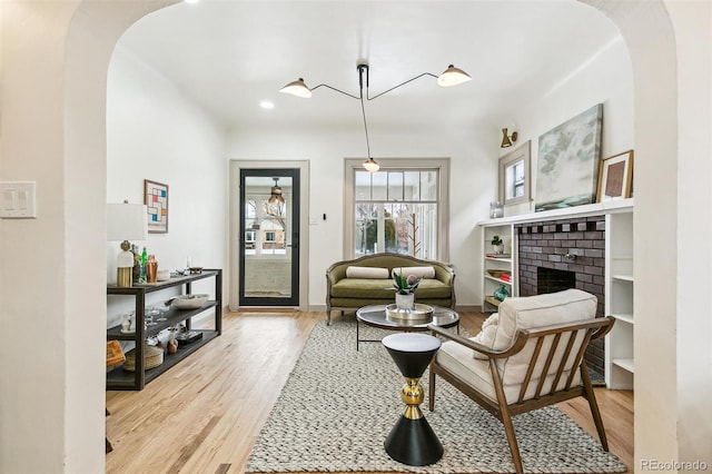 living area featuring a fireplace and light hardwood / wood-style flooring