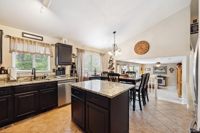 23634 Broadmoor Dr, Parker, CO 80138 - kitchen with stainless steel dishwasher, light tile patterned floors, a chandelier, healthy amount of natural light, and high vaulted ceiling
