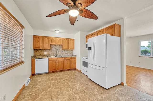 3490 Mowry Pl, Westminster, CO 80031 - kitchen featuring white appliances, ceiling fan, backsplash, and brown cabinets