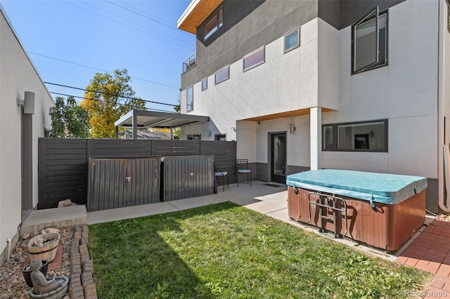 view of yard with a hot tub, fence, and a patio