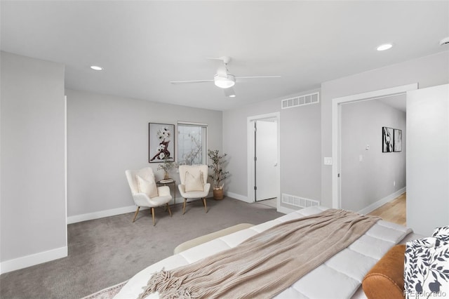 bedroom featuring baseboards, visible vents, and light colored carpet