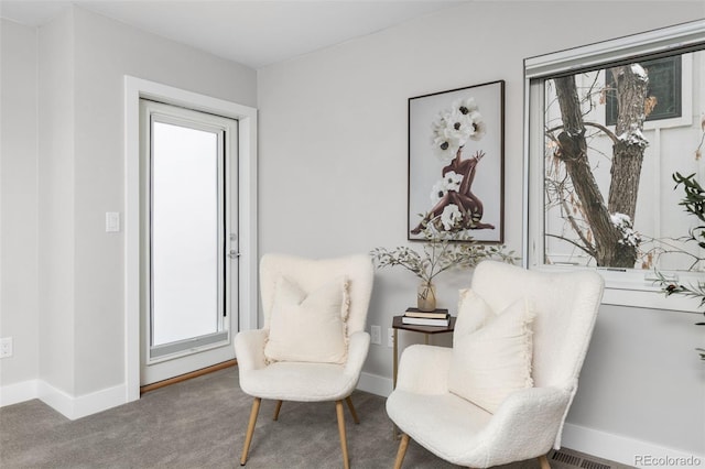 living area featuring carpet floors and baseboards