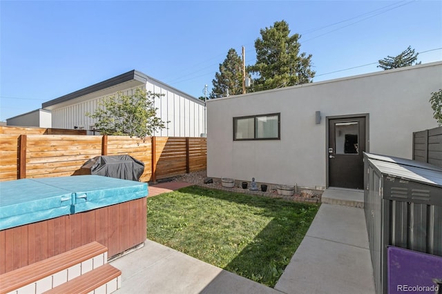 view of yard featuring a hot tub and fence