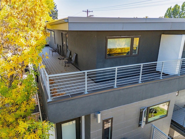 exterior space featuring a balcony and stucco siding