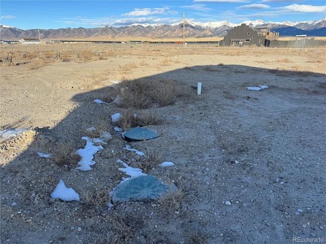 view of yard with a rural view and a mountain view