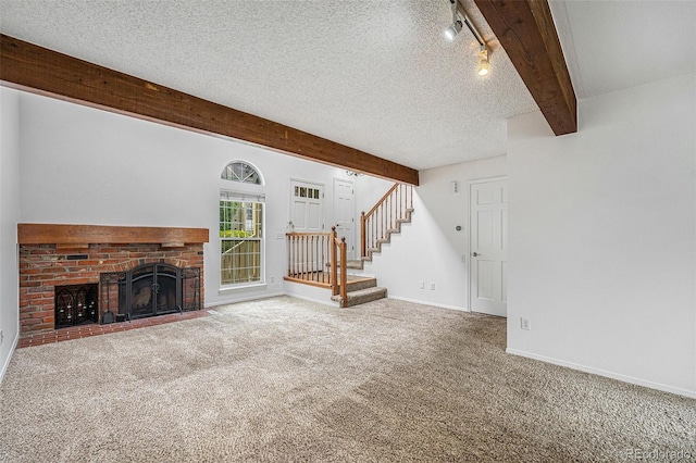 1915 S Hannibal St Unit G, Aurora, CO 80013 - unfurnished living room with beam ceiling, stairway, carpet, baseboards, and a fireplace
