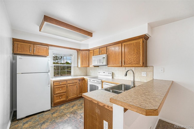 1915 S Hannibal St Unit G, Aurora, CO 80013 - kitchen with white appliances, a peninsula, a sink, and backsplash