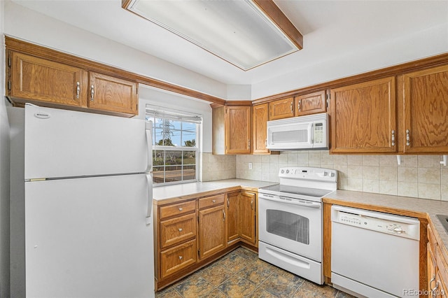 1915 S Hannibal St Unit G, Aurora, CO 80013 - kitchen with white appliances, backsplash, light countertops, and brown cabinets