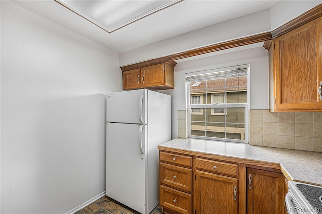 1915 S Hannibal St Unit G, Aurora, CO 80013 - kitchen featuring white appliances, decorative backsplash, light countertops, and brown cabinetry