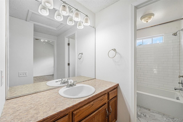 1915 S Hannibal St Unit G, Aurora, CO 80013 - bathroom featuring vanity,  shower combination, marble finish floors, and a textured ceiling