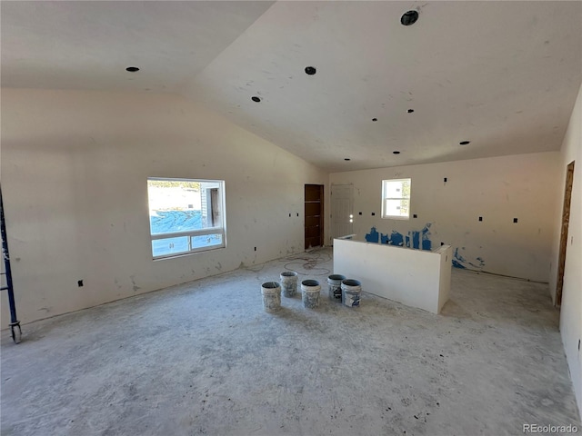 unfurnished living room featuring lofted ceiling