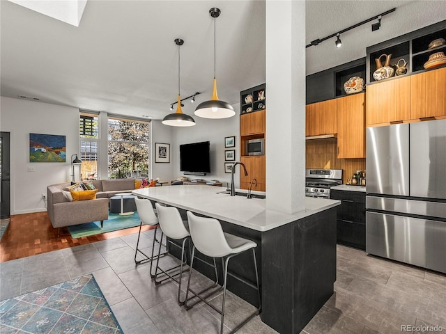 3133 Blake St Unit 3, Denver, CO 80205 - kitchen with stainless steel appliances, a sink, open floor plan, open shelves, and light countertops