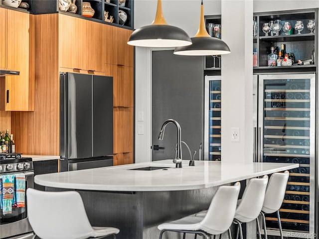 3133 Blake St Unit 3, Denver, CO 80205 - kitchen with freestanding refrigerator, a sink, gas stove, beverage cooler, and modern cabinets