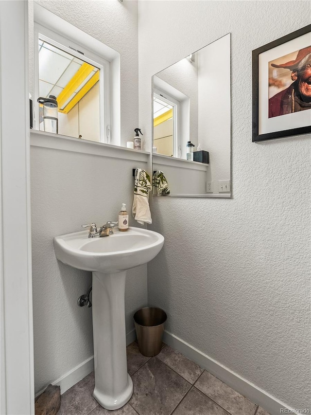 3133 Blake St Unit 3, Denver, CO 80205 - bathroom with tile patterned flooring, a sink, and baseboards