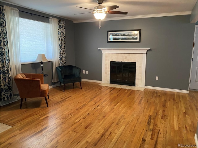 542 E Caley Dr, Centennial, CO 80121 - sitting room with wood finished floors, ceiling fan, crown molding, baseboards, and a tile fireplace
