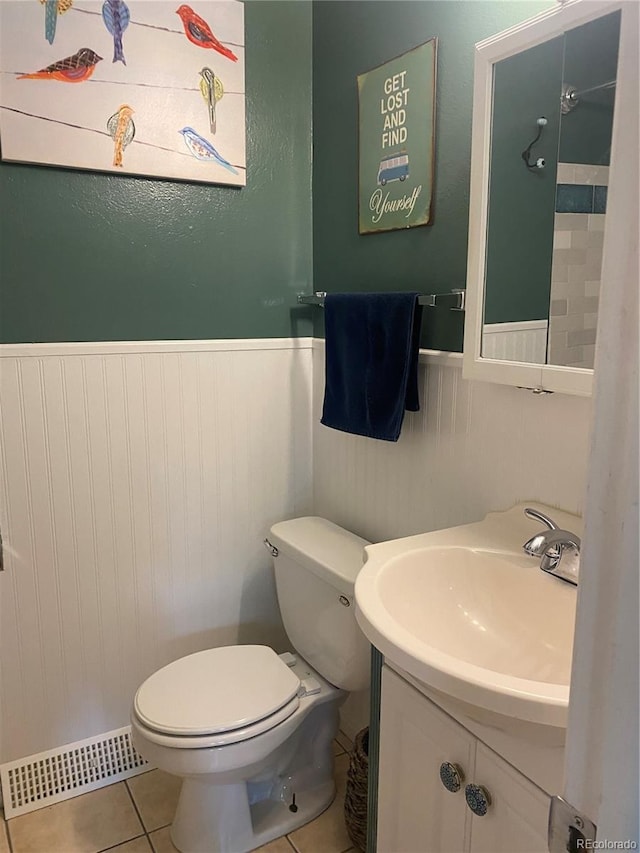 542 E Caley Dr, Centennial, CO 80121 - bathroom with a wainscoted wall, toilet, tile patterned floors, and vanity