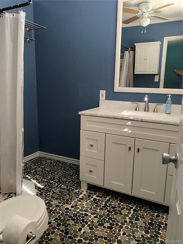 542 E Caley Dr, Centennial, CO 80121 - full bath featuring ceiling fan, vanity, a shower with curtain, stone finish floors, and baseboards