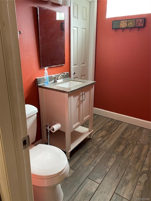 542 E Caley Dr, Centennial, CO 80121 - bathroom with toilet, wood finished floors, vanity, and baseboards
