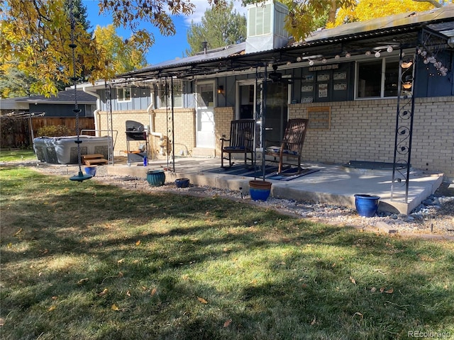 542 E Caley Dr, Centennial, CO 80121 - rear view of property with brick siding, a patio area, and a hot tub