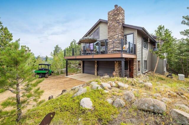 view of side of home with a balcony and a garage