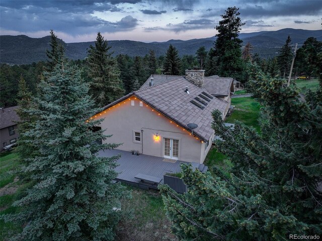 96 Carolyn Rd, Evergreen, CO 80439 - aerial view of property and surrounding area with mountains and a forest